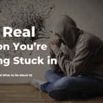 Blog cover image of a man sitting in thought with messy scribbles on the wall, symbolizing feeling stuck in life and mental overwhelm.